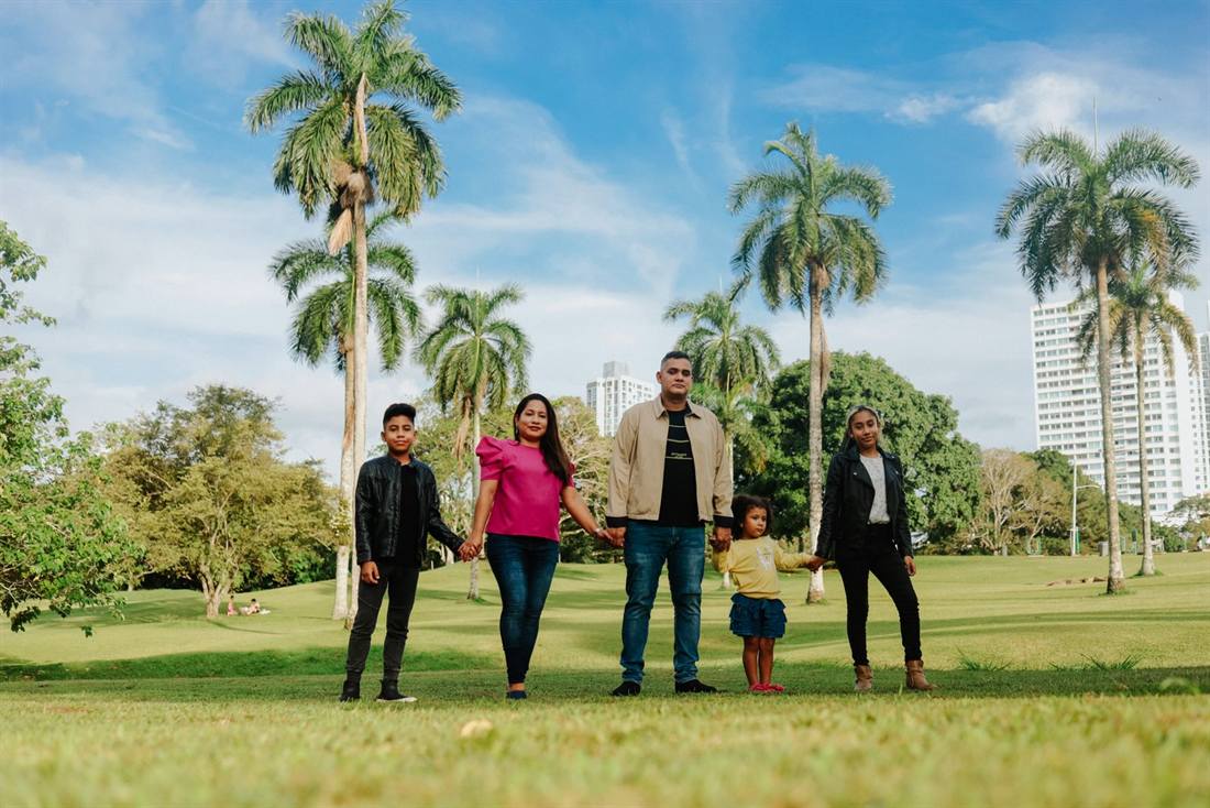 A Miami family in front of their new home
